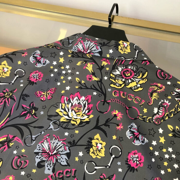 Tessuto Gucci floreale con farfalle, stelle, logo, perfetto per alta moda di lusso.
