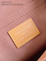 Etichetta in pelle Louis Vuitton di lusso in borsa elegante, con logo inciso e finiture raffinato.