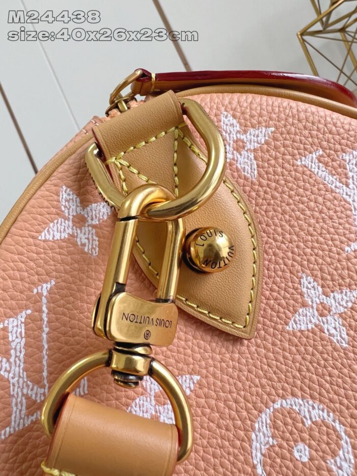 Borsa di lusso in pelle pesca con dettagli in oro e logo iconico.