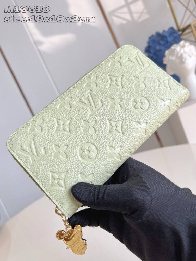 Portafoglio Louis Vuitton verde menta con zip e charm, elegante e di lusso.