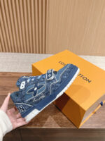 Sneaker Louis Vuitton navy in denim con logo, esposta su tavolo elegante, logo LV visibile.
