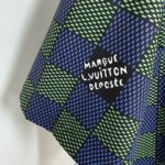 Tessuto di lusso blu e verde con logo Louis Vuitton, pattern geometrico e dettagli eleganti.