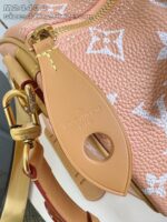 Borsa di lusso in pelle pesca con zip dorata e dettagli eleganti in metallo e pelle.