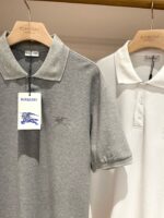 Polo Burberry grigia e bianca di alta qualità, eleganti e perfette per ogni occasione.