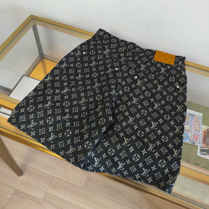 Pantaloncini Louis Vuitton monogramma neri su vetrina con dettagli in pelle caramel.