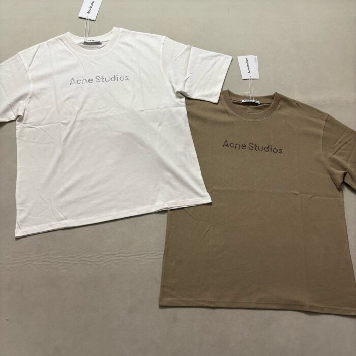 Magliette minimaliste Acne Studios bianca e beige, made in Italia, stile casual e raffinato.