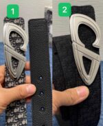 Confronto tra cintura casual con logo e cintura elegante nera con fibbia raffinata.