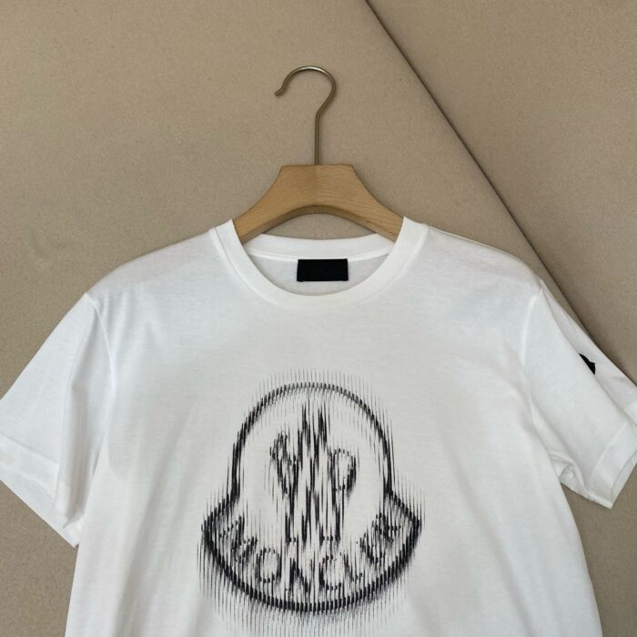 T-shirt bianca Moncler con logo grafico, stile streetwear e casual, perfetta per ogni outfit.