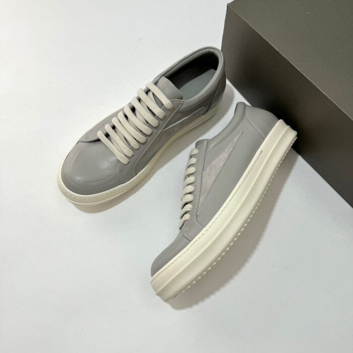 Scarpe sneakers grigie moderne con suola bianca, stile versatile e design elegante per ogni outfit.