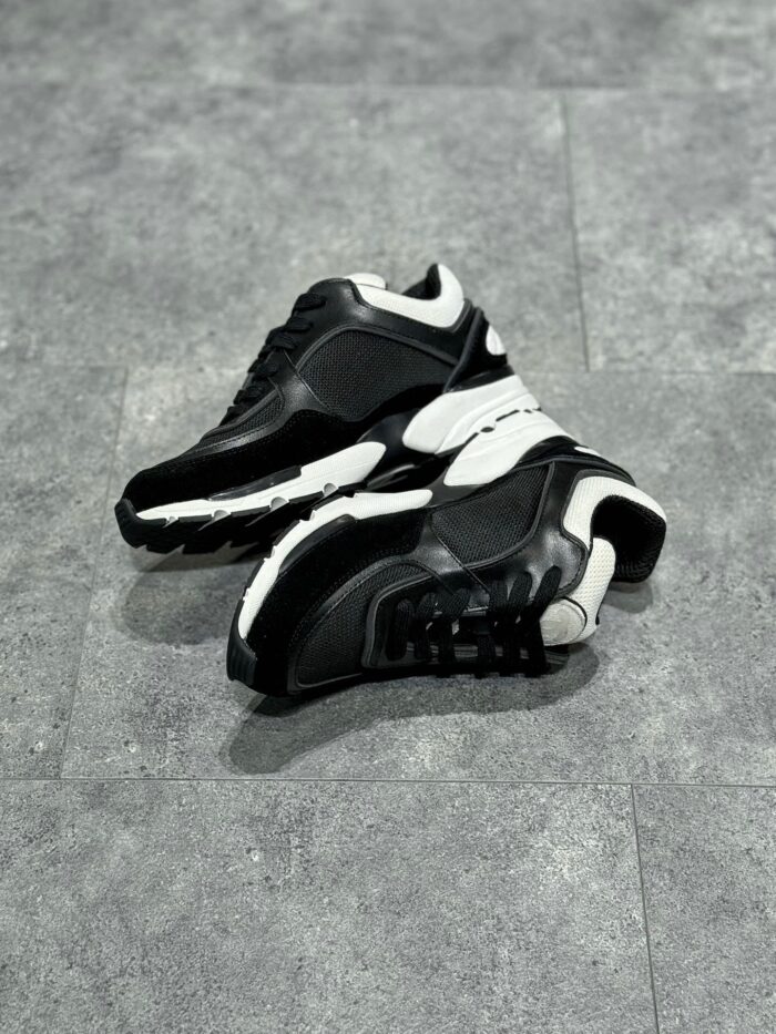 Scarpe sportive nere e bianche, comfort, stile urbano, suola performante e design moderno.