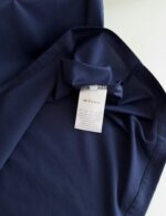 Tessuto navy blue di alta qualità con etichetta di cura e finiture raffinate.