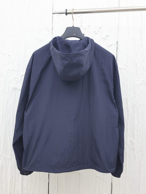 Giacca leggera navy con cappuccio, stile minimalista, perfetta per ogni occasione.