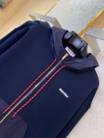 Felpa navy con zip rossa, cappuccio strutturato e tasca più spaziosa elegante e moderna.