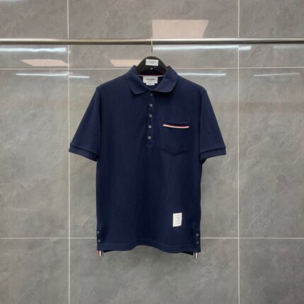 Maglietta polo navy uomo, elegante e versatile, con taschino a contrasto e dettagli a strisce.