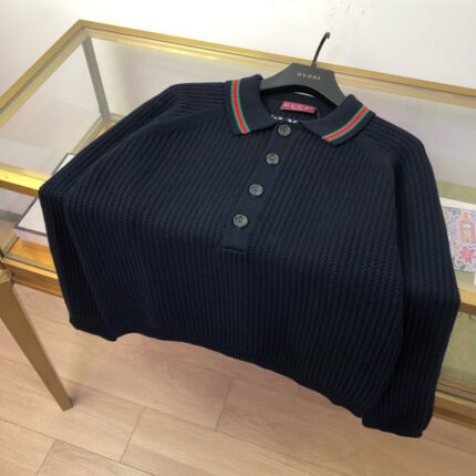 Maglietta polo navy con colletto a righe verde e rossa, stile elegante e casual.