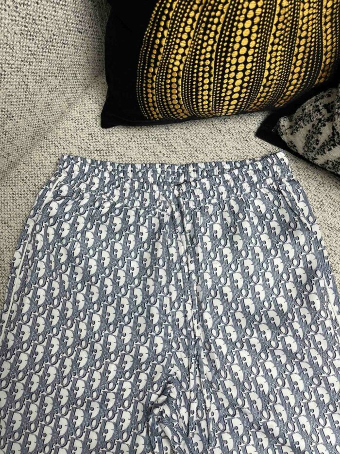 Pantaloni a motivi blu e bianco su divano con cuscini decorativi eleganti e confortevoli.