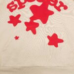 Felpa beige con stampa sugar e stelle rosse giocose, casual e trendy.