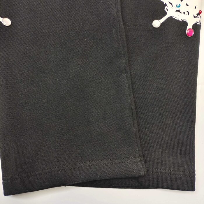 Pantaloni neri in cotone con stampa divertente e vivace, ideali per bambini e casualità.