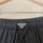 Pantaloni shorts Prada neri leggeri, resistenti allacqua, con logo triangolare in metallo