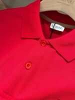 Polo rossa Burberry di lusso, tessuto elastico, dettagli eleganti, stile casual sofisticato.