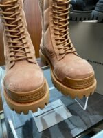 Stivali beige in pelle con suola rugged, dettagli gold e design elegante per ogni avventura.