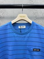 Maglietta casual blu con righe, tasca e etichetta Miu Miu, stile moderno ed elegante.
