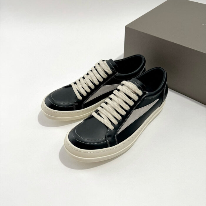 Sneakers nere in pelle con banda bianca e lacci crema, stile moderno e versatile.