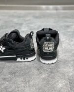 Sneakers nere di lusso con logo a stella e ricamo 23, stile urbano e moderno.
