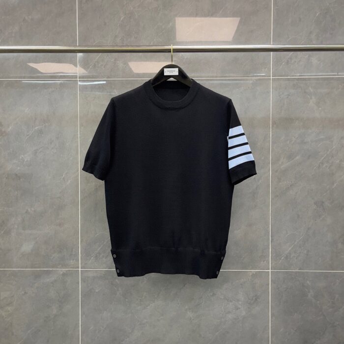 Maglietta nera con strisce blu, girocollo, dettaglio a bottoni, stile sporty e versatile.