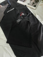 Outfit di lusso con top nero e borsa Saint Laurent elegante.