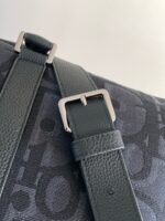 Borsa moderna in ecopelle con tracolla in verde scuro e fibbia in metallo argentato.