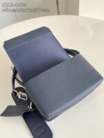 Elegante borsa in pelle blu con tracolla regolabile, design minimalista e stile sofisticato.