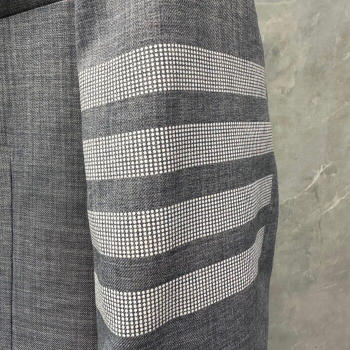 Manica in tessuto grigio con strisce moderne e motivo a quadri, stile elegante e contemporaneo.
