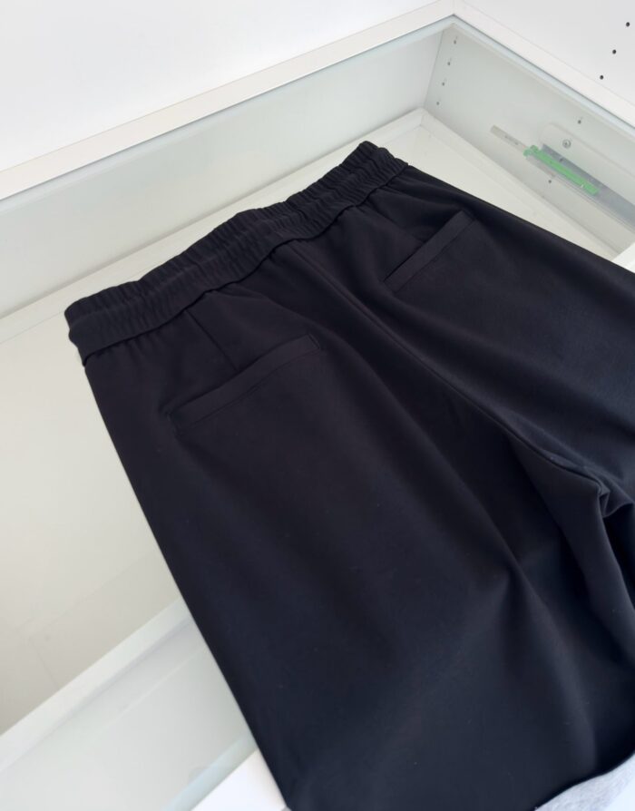 Pantaloni neri comodi elasticizzati con tasche posteriori, stile minimalista e adatti a ogni occasione.