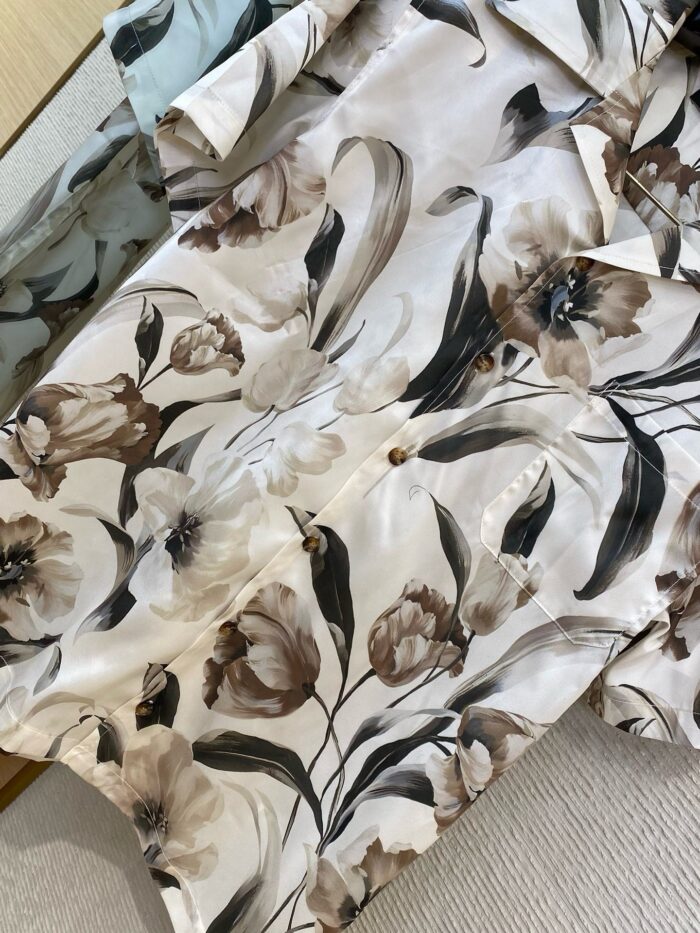 Elegant floral fabric with beige, cream, brown flowers and green leaves for spring attire.