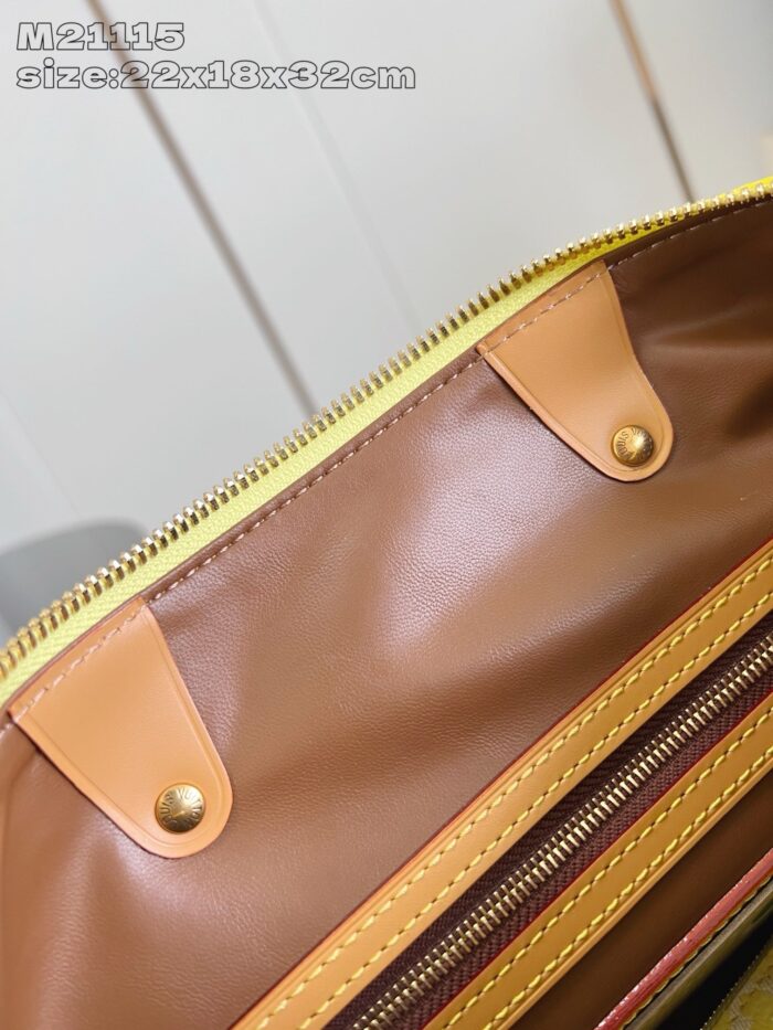 Interno di borsa in pelle con dettagli dorati, compartimenti organizzatori e stile elegante.