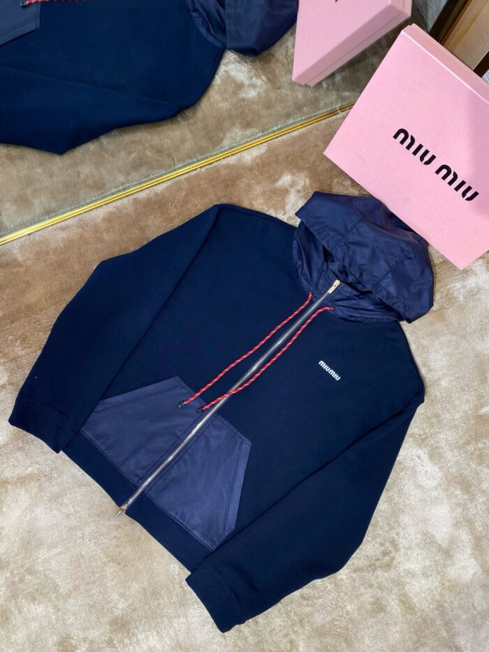 Felpa navy con cappuccio, cerniera e dettagli colorati, stile moda e lusso di Miu Miu.