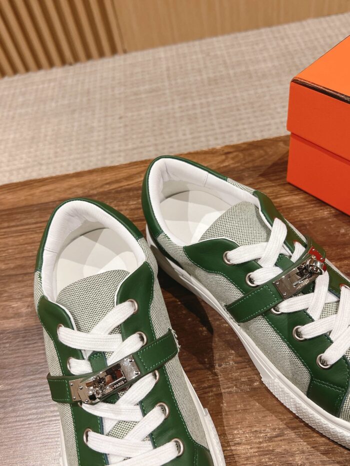 Sneakers moderne verde e grigia con dettagli metallici su tavolo in legno, stile di lusso.
