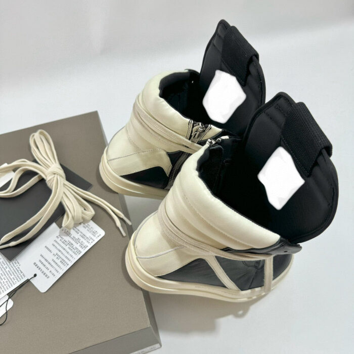 Sneakers alte in crema e nero con zip, supporto alla caviglia e design moderno e trendy.