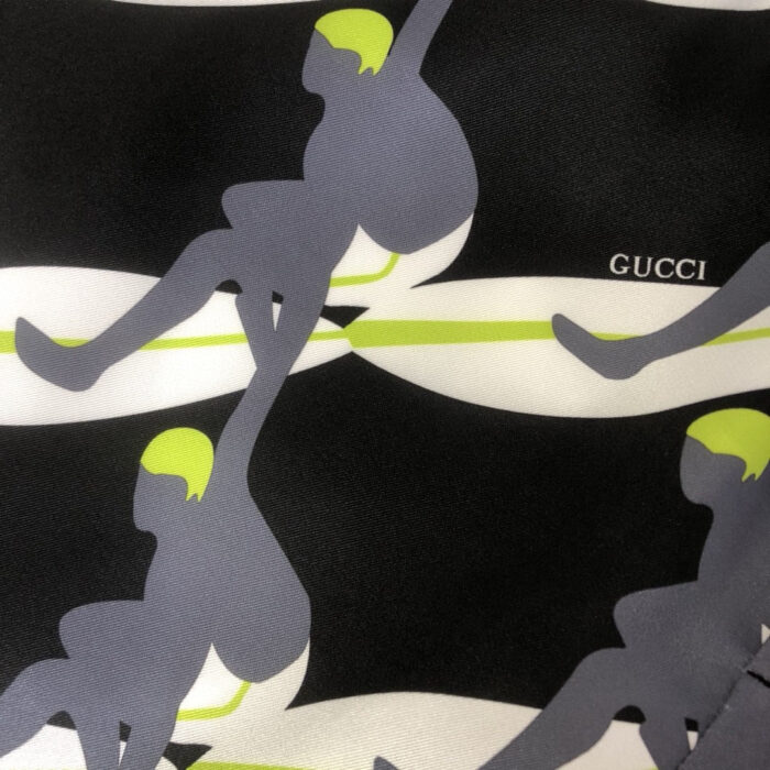 Motivi astratti Gucci con figure stilizzate, linee colorate e logo discreto su sfondo nero.