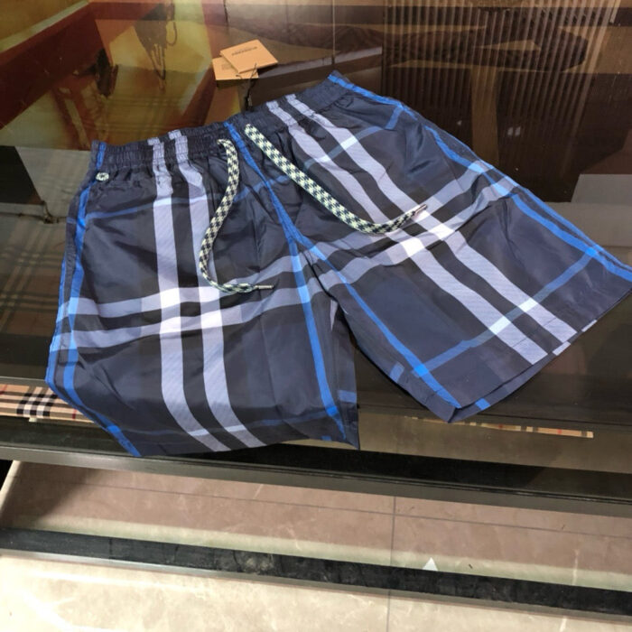 Costumi da nuoto a quadri blu trendy, con cintura con cordino e stile estivo.