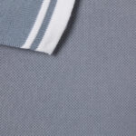 Polo grigia con colletto a righe bianche, tessuto morbido e stile moderno ed elegante.