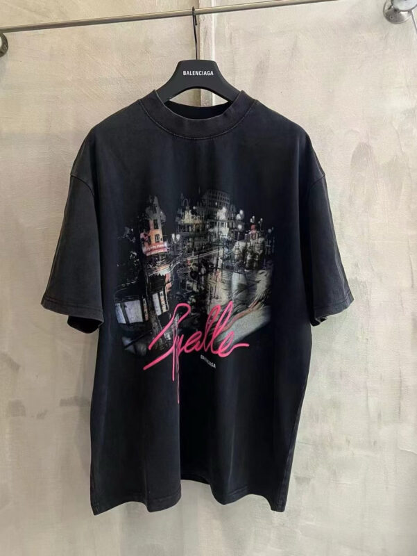 T-shirt oversized nero con grafica urbana colorata e testo neon rosa, stile streetwear trendy.