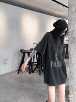 giovane uomo streetwear con tatuaggi in ambiente industriale minimalista con luce naturale