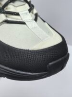 Sneaker moderna neutra con dettagli neri, suola flessibile e design urbano versatile.