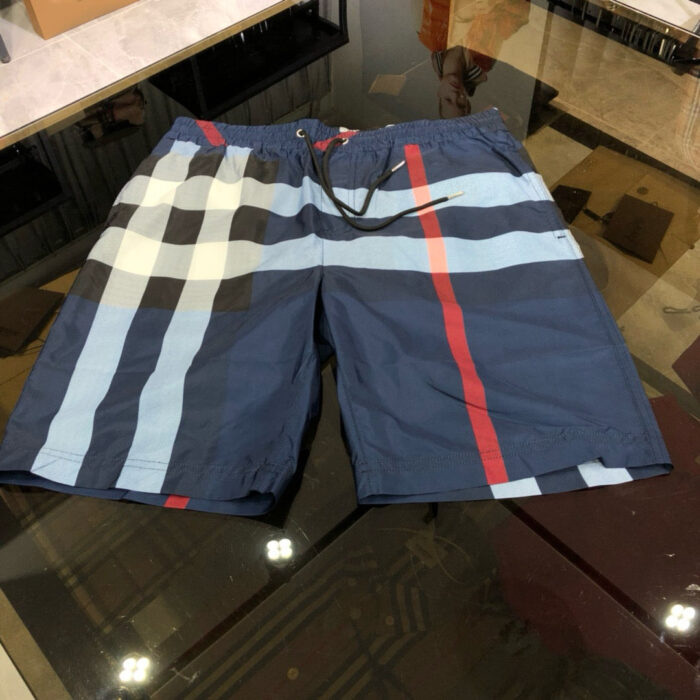 Pantaloncini da spiaggia navy con pattern geometrici moderni e cintura elasticizzata.