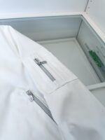 Giacca bianca moderna con tasca a zip sulla manica, stile minimalista e versatile.