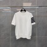 Maglione bianco casual con strisce nere e dettagli bottoni, versatile e moderno.