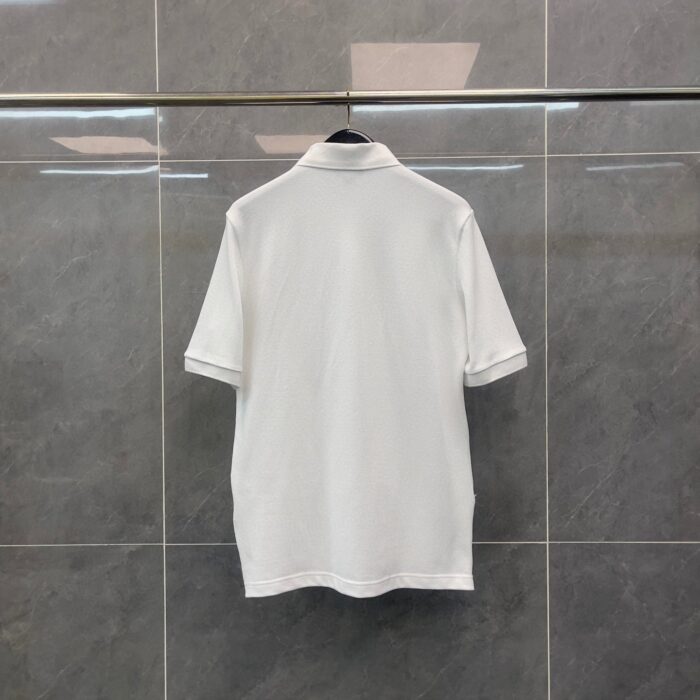 Maglietta polo bianca classica su gancio moderno, perfetta per look casual ed elegante.
