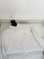 Camicia bianca elegante con logo discreto, perfetta per uno stile raffinato e versatile.